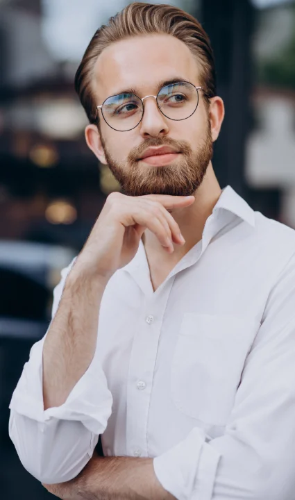 A woman seated on a chair, elegantly dressed in a luxurious fur coat.